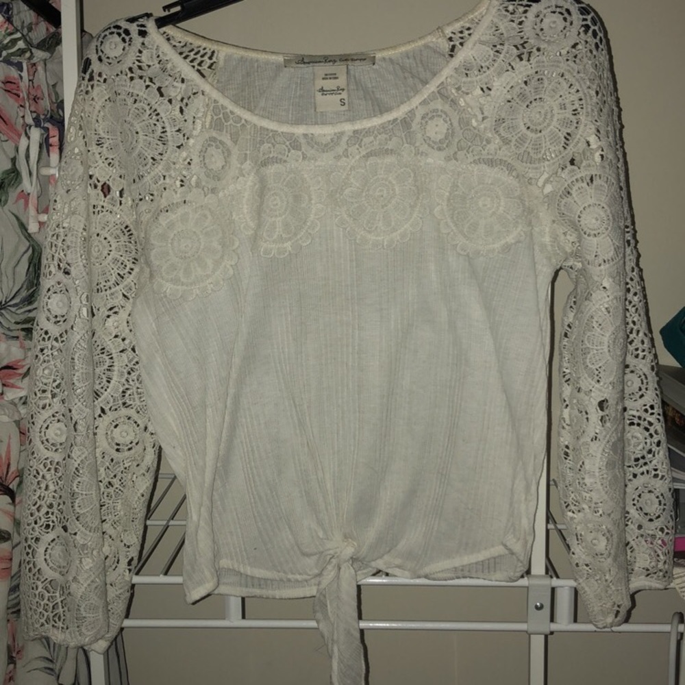 White blouse, tye in the bottom, w/ white floral